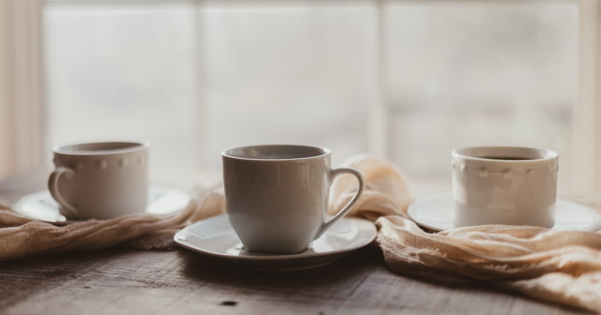 Coffee cups on saucers on a rustic wooden table