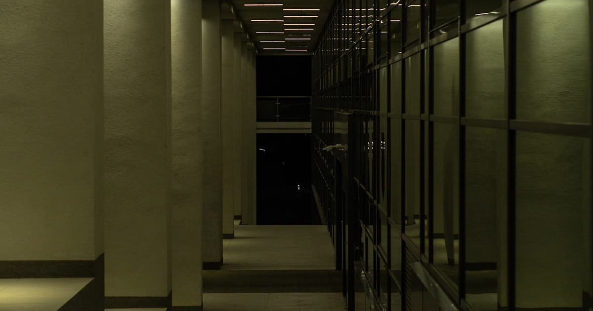 A dimly lit office corridor at night