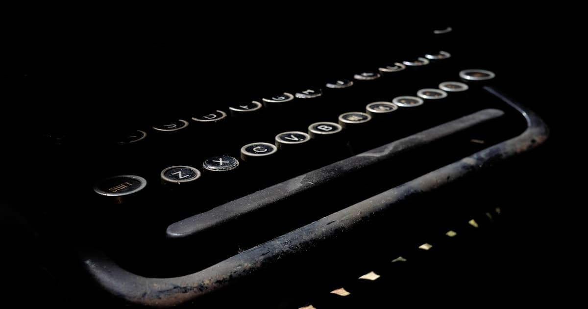 A vintage typewriter keyboard in dim light
