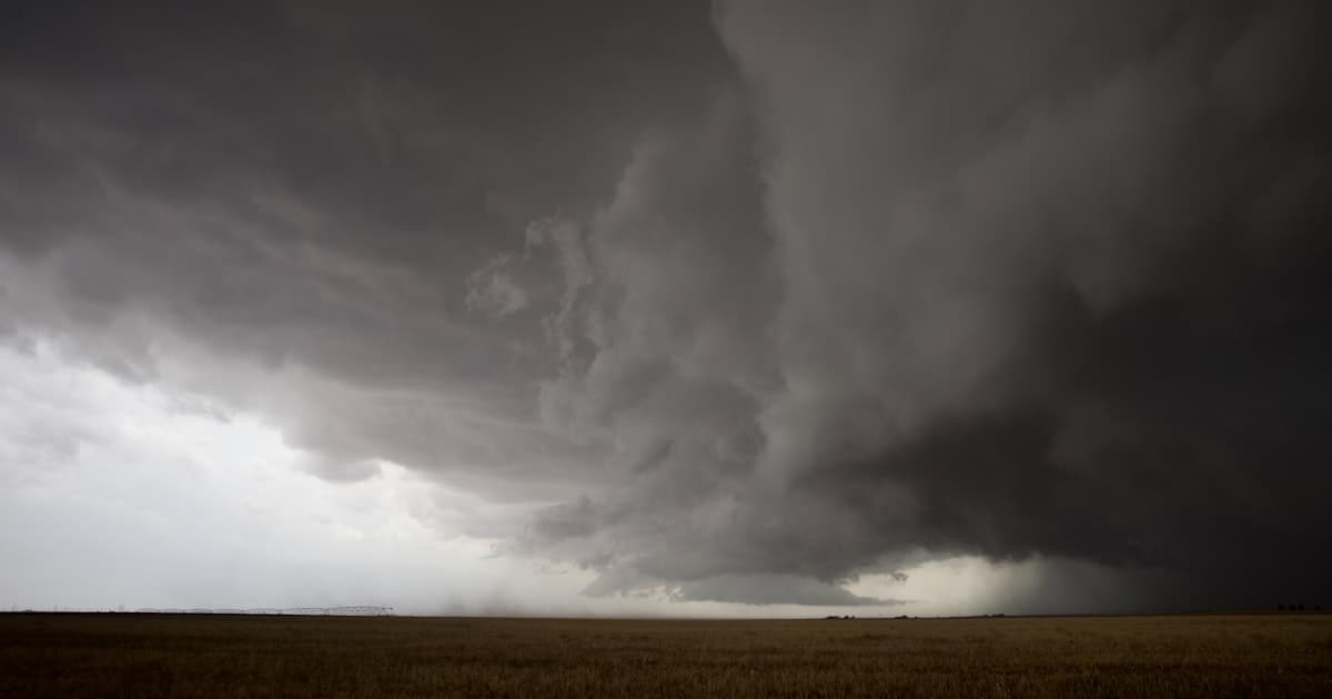 Dark storm clouds looming over an open field
